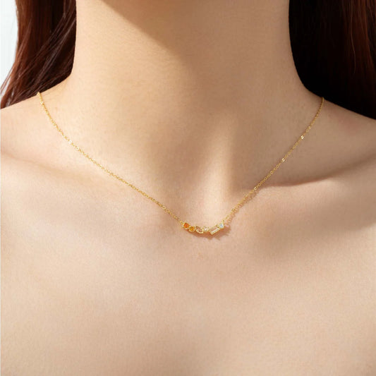 Woman wearing gold long chain birthstone necklace – elegant blue pendant jewelry