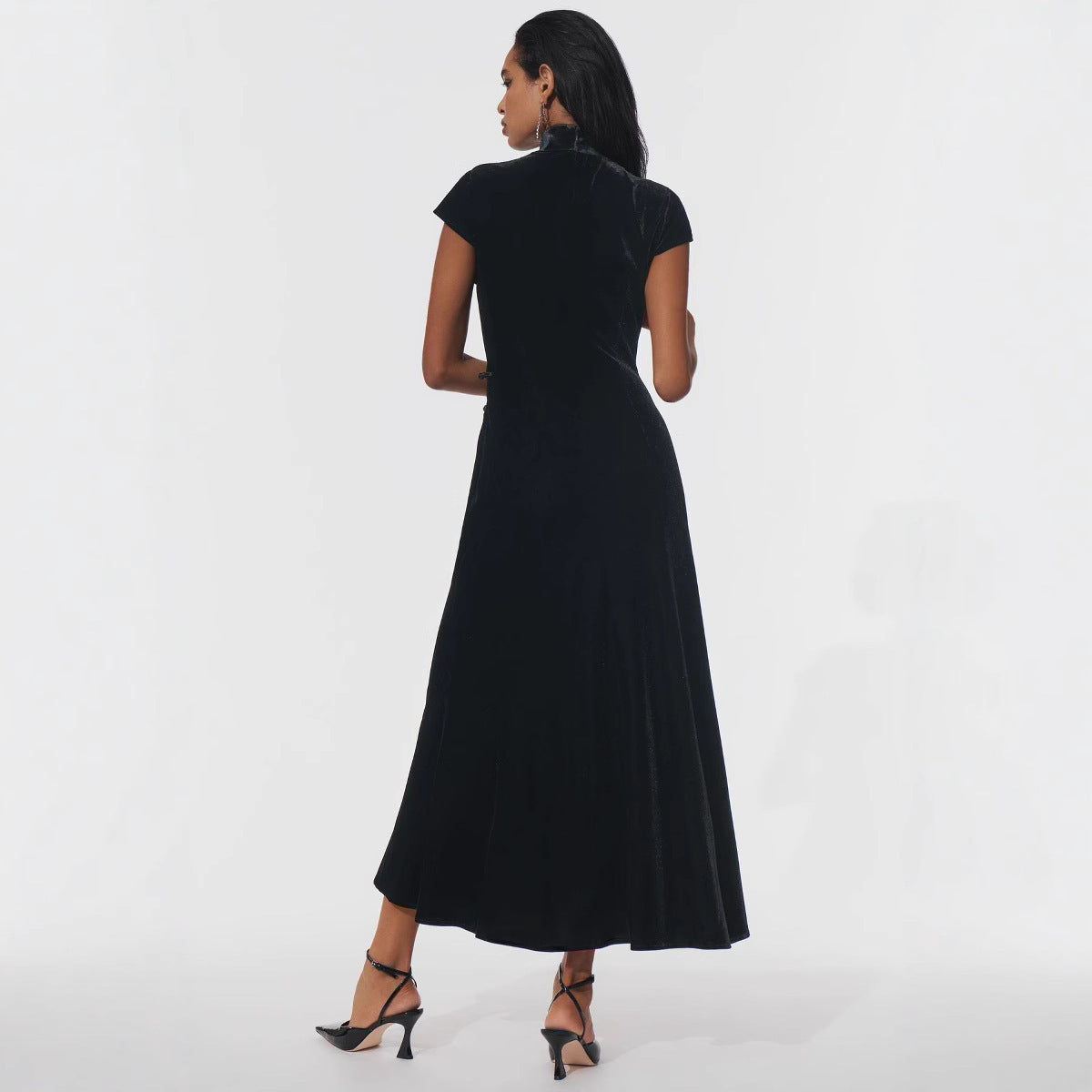 Elegant black high-waist floor-length dress with subtle split and cutout detail, slim-fit evening gown for formal occasions.