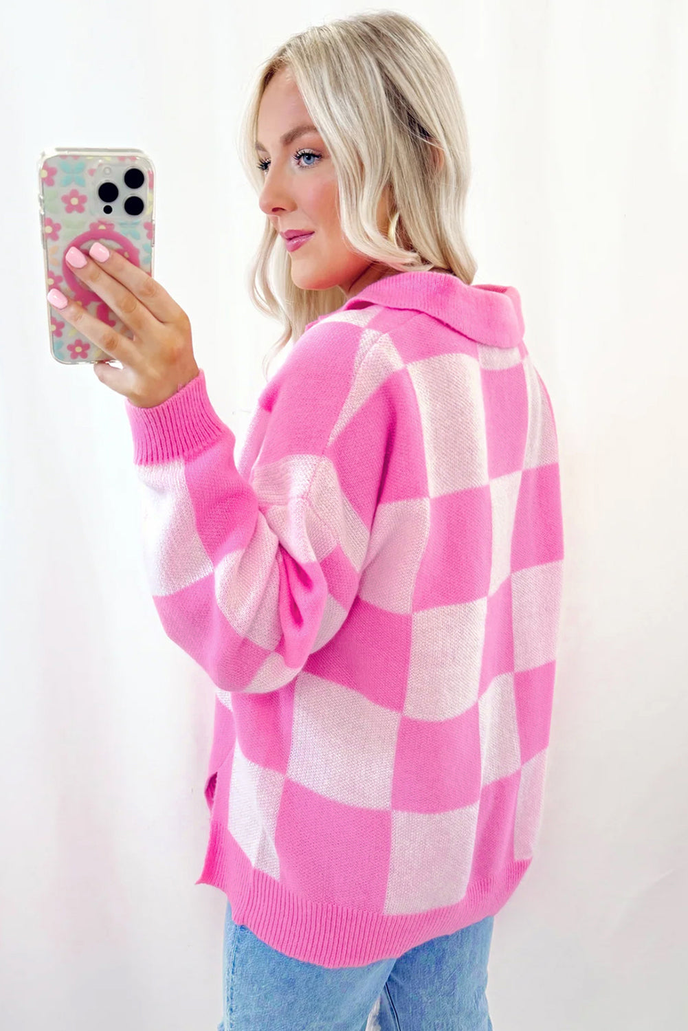 Woman wearing pink checkerboard sweater – trendy autumn casual outfit