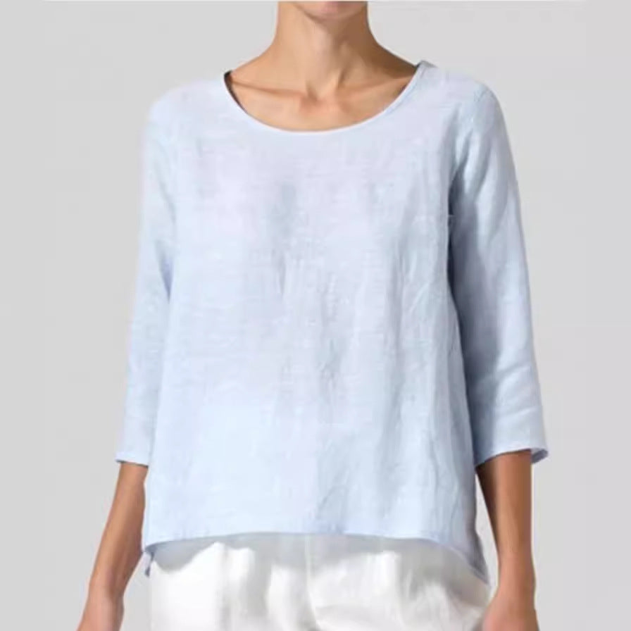 Light blue top worn by a person on a plain background