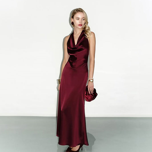 Wine-red satin halter maxi dress with open back and high-waist slim silhouette, elegant floor-length evening gown for formal occasions.