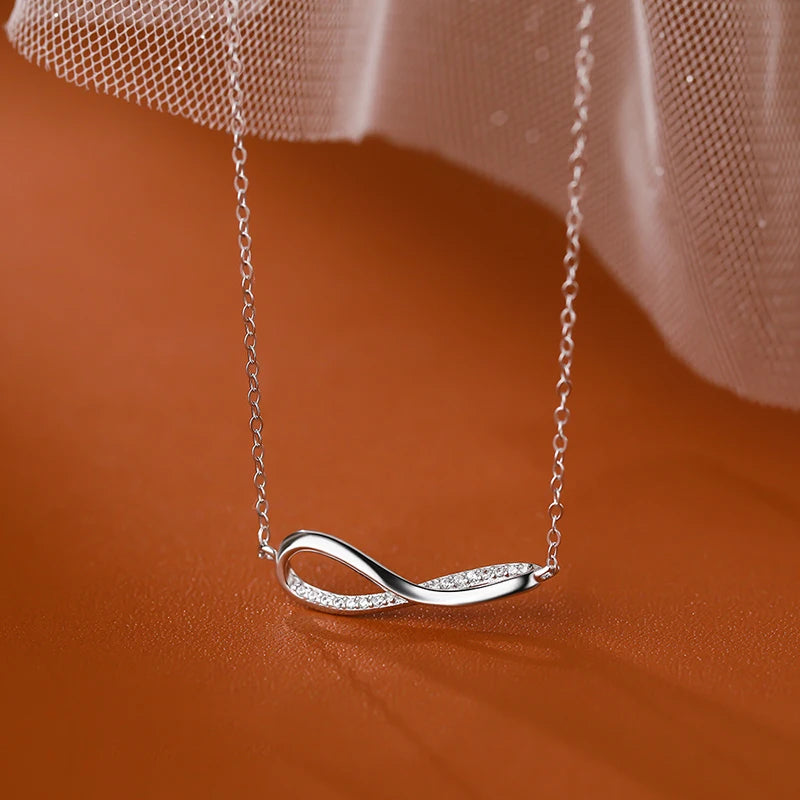 Polished sterling silver infinity pendant on delicate chain