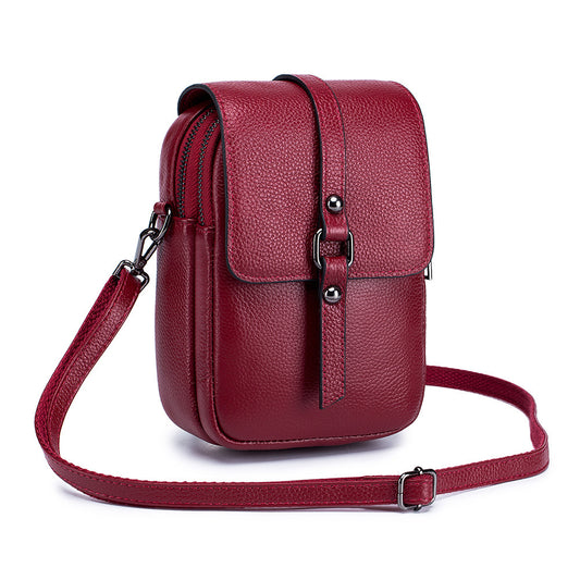 Red leather crossbody bag on a white background