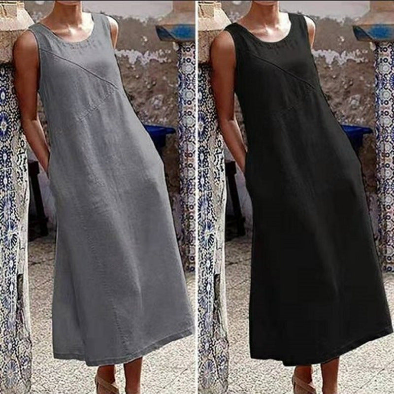 Two dresses, one gray and one black, on a mannequin against a patterned wall.