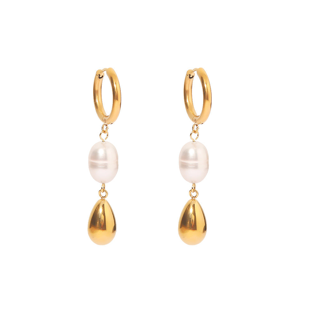 Gold hoop earrings with pearl and teardrop charms on a white background