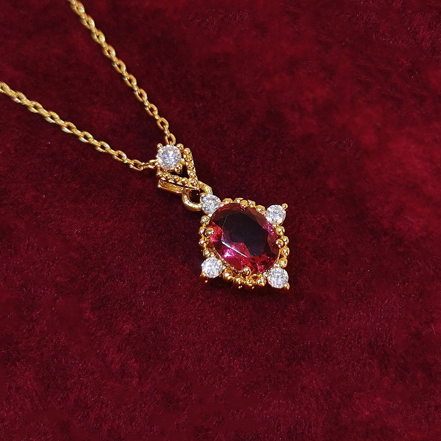 Gold plated necklace with red ruby pendant and delicate adjustable chain for women.