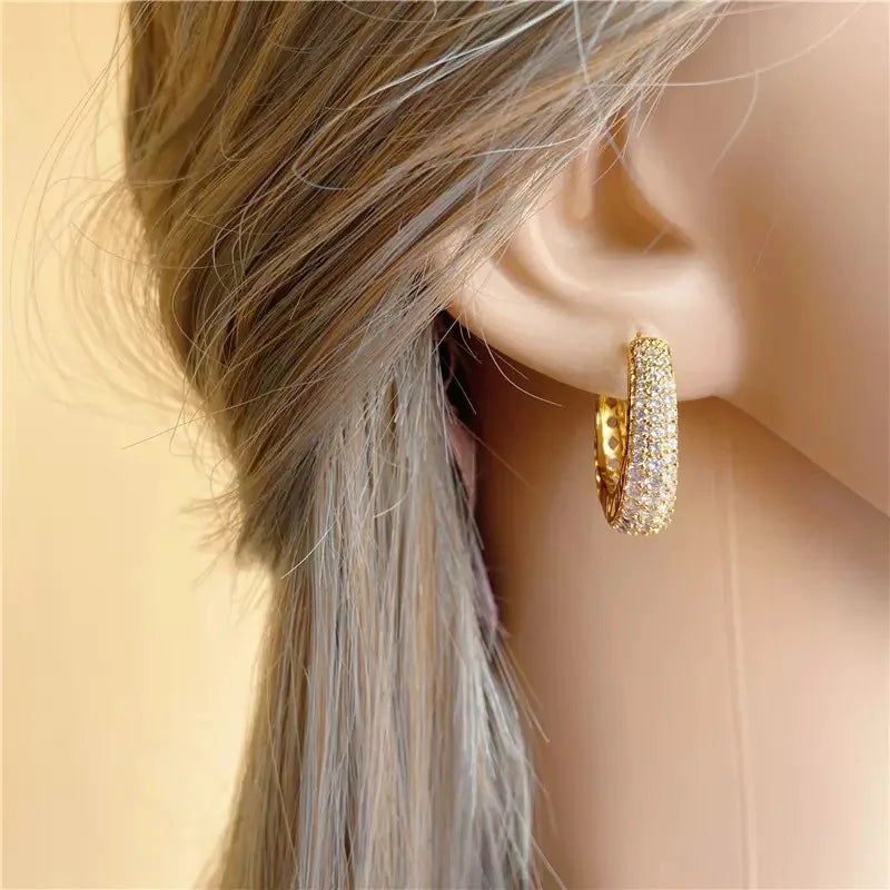 Woman wearing Huitan gold CZ hoop earrings – elegant party jewelry