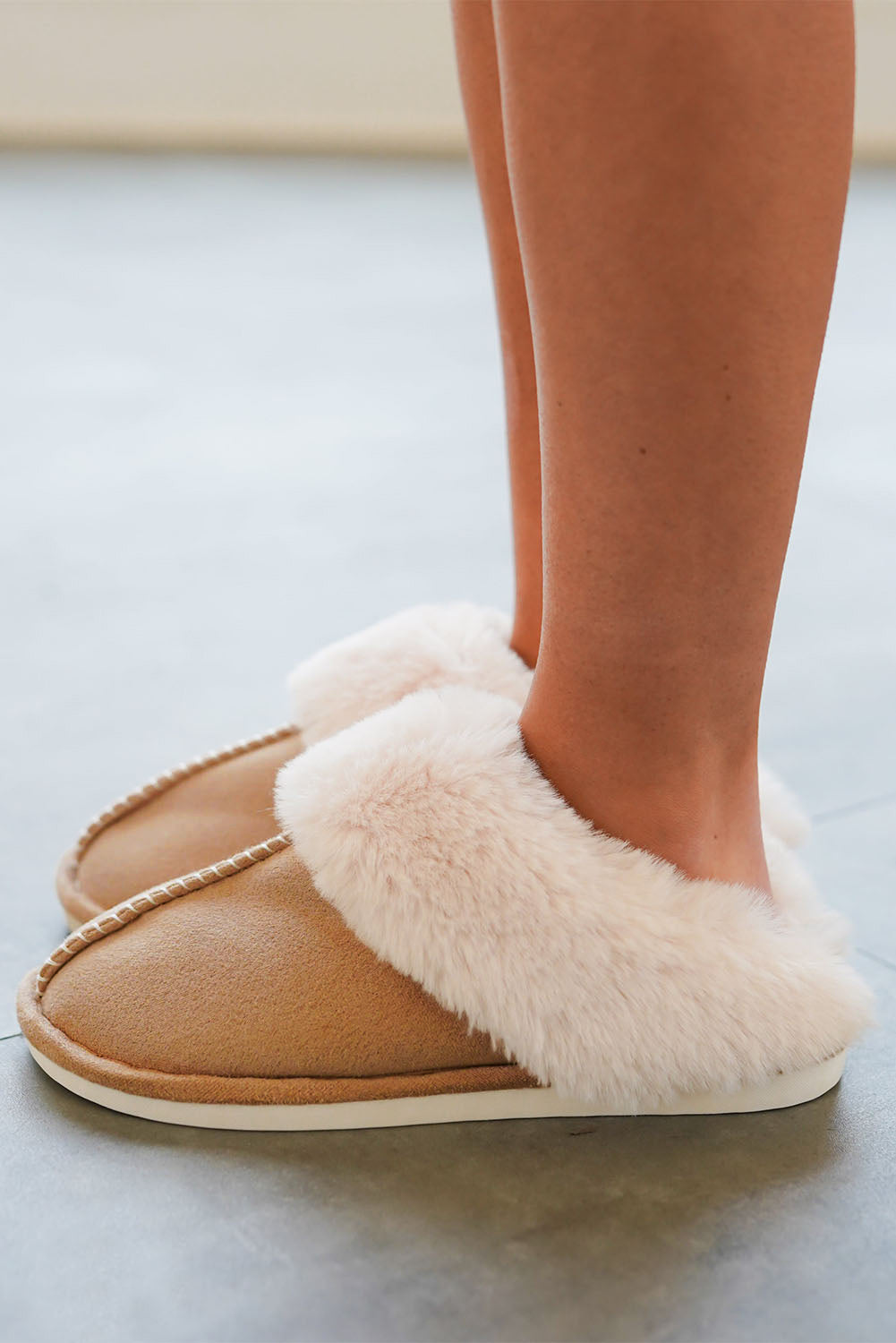 Woman wearing camel suede slippers at home – elegant winter comfort footwear