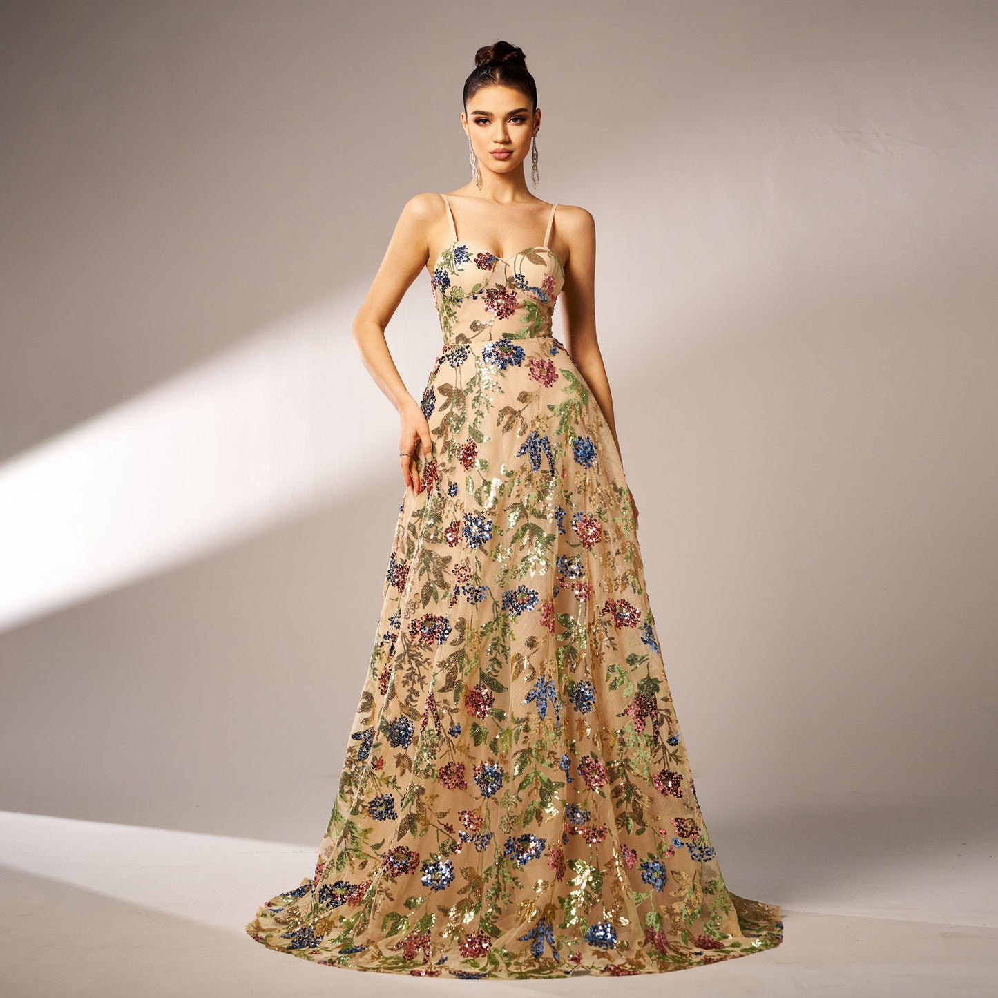 Woman wearing a floral evening gown against a neutral background