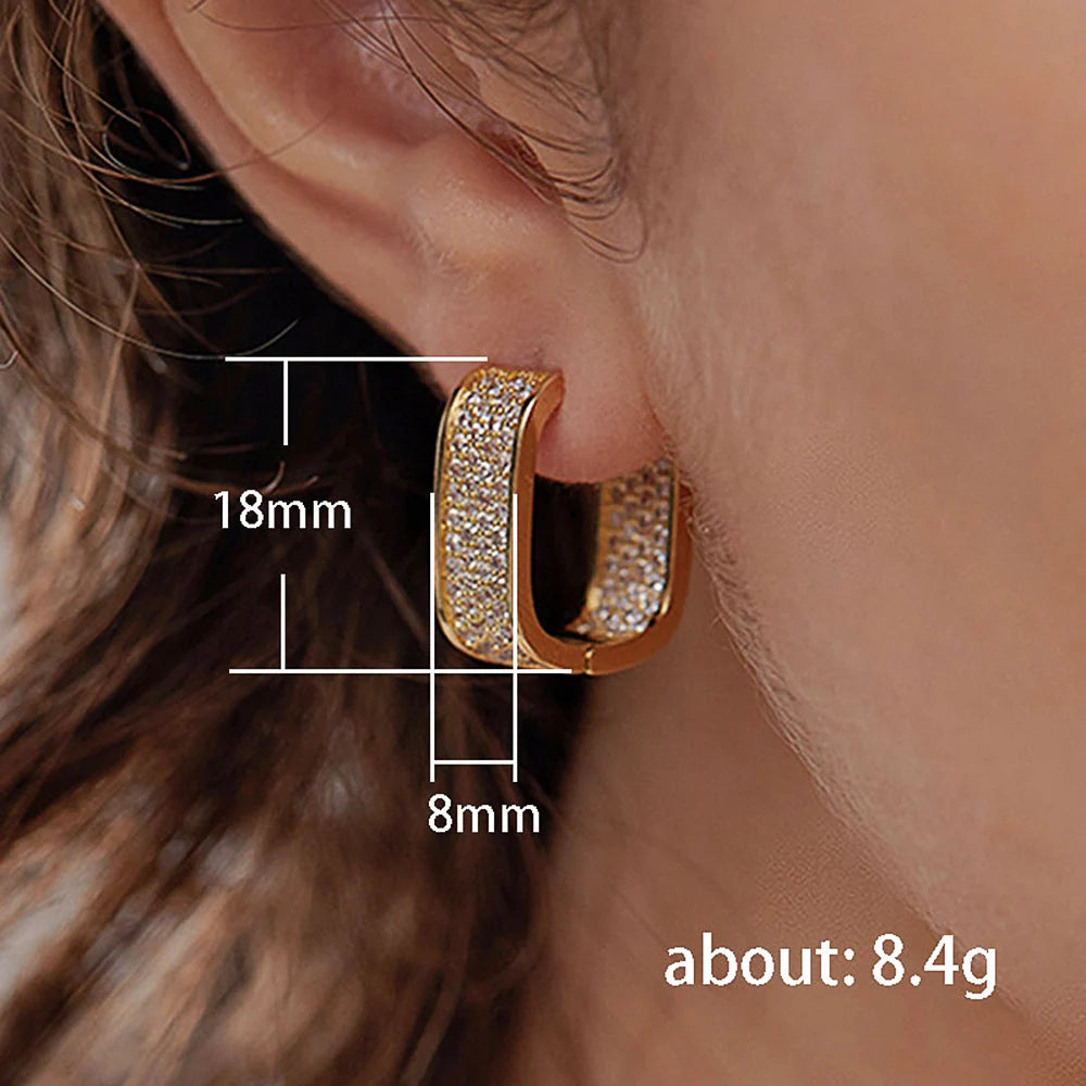 Woman wearing sparkling CZ hoop earrings – perfect for fashion or parties