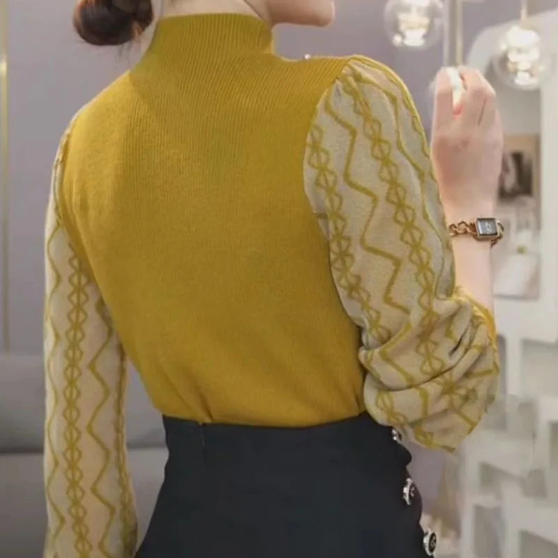 Textured knit hollow-out detailing on soft spliced sweater fabric.