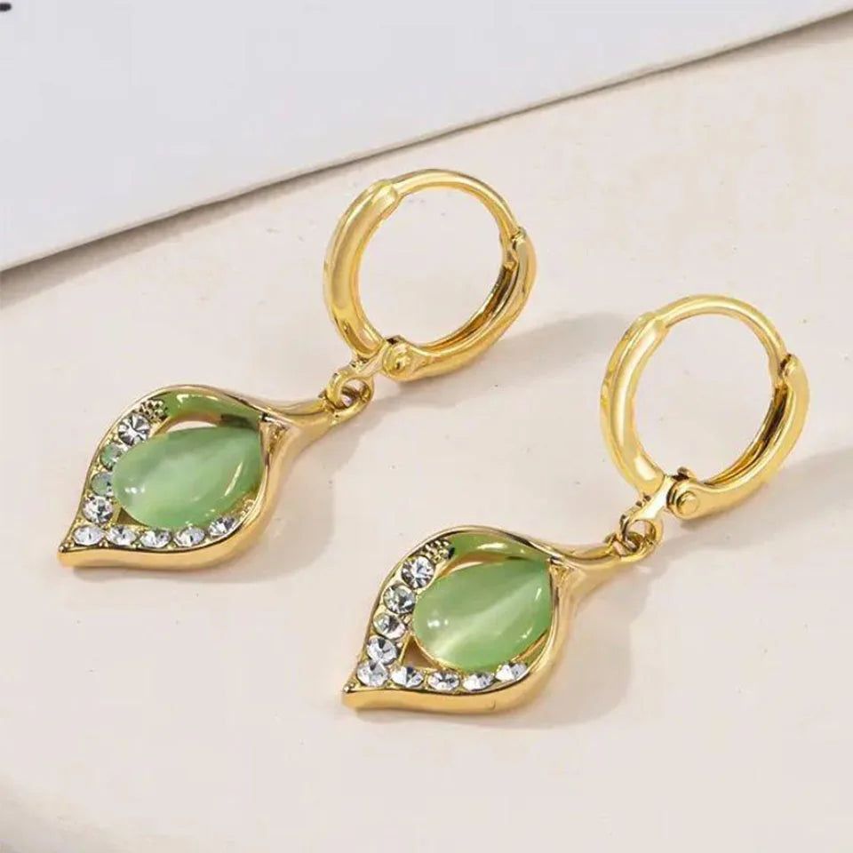 Detailed gold-plated hoop earrings with sparkling rhinestone inlay.