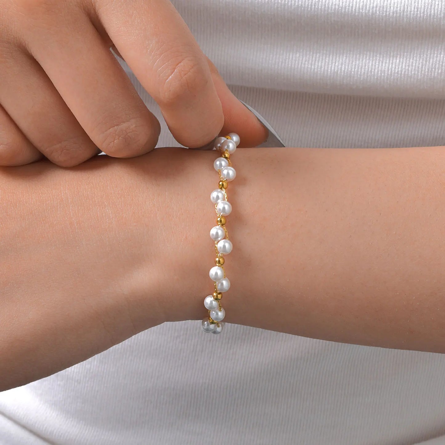 Woman wearing minimalist gold bead bracelet – modern light luxury fashion