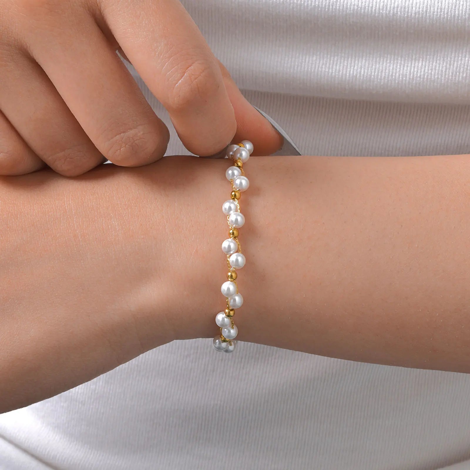 Woman wearing minimalist gold bead bracelet – modern light luxury fashion