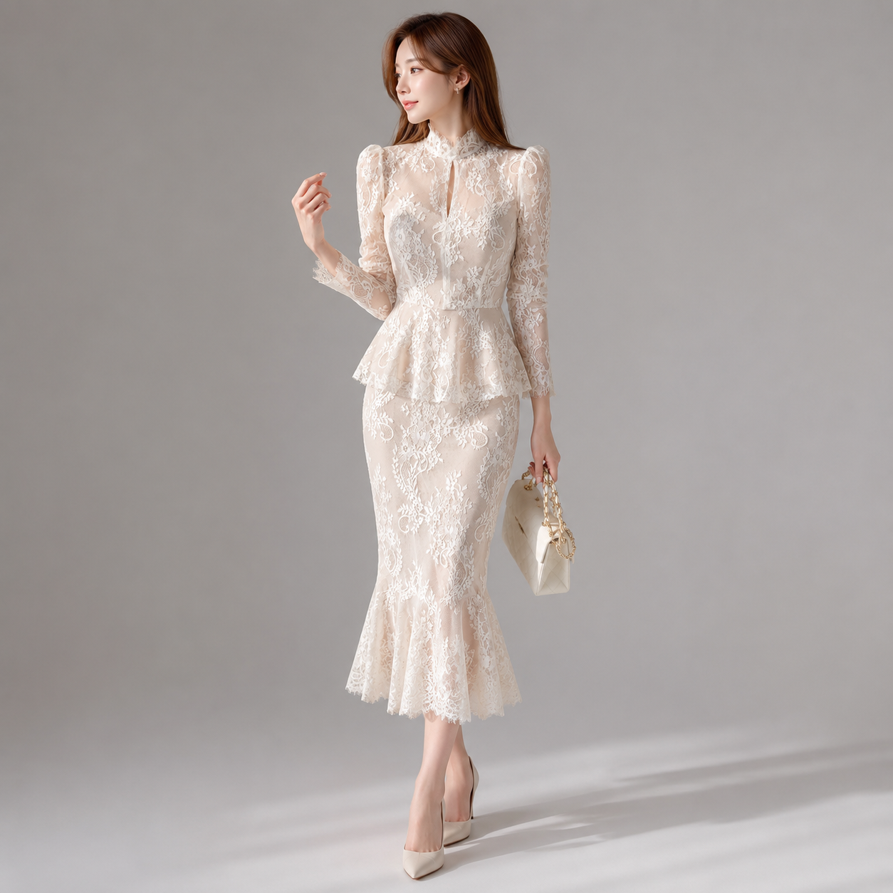 Woman wearing a white lace dress against a gray background
