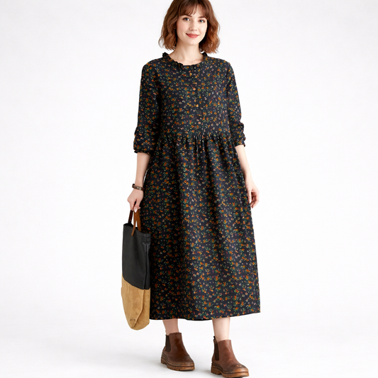 Woman wearing a floral dress holding a black and brown bag on a white background