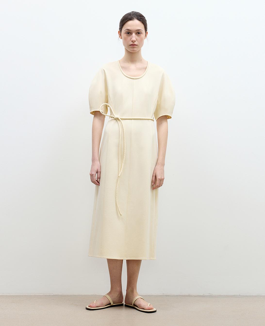 Model wearing April Story knitted dress – modern minimalist style in textured cotton.