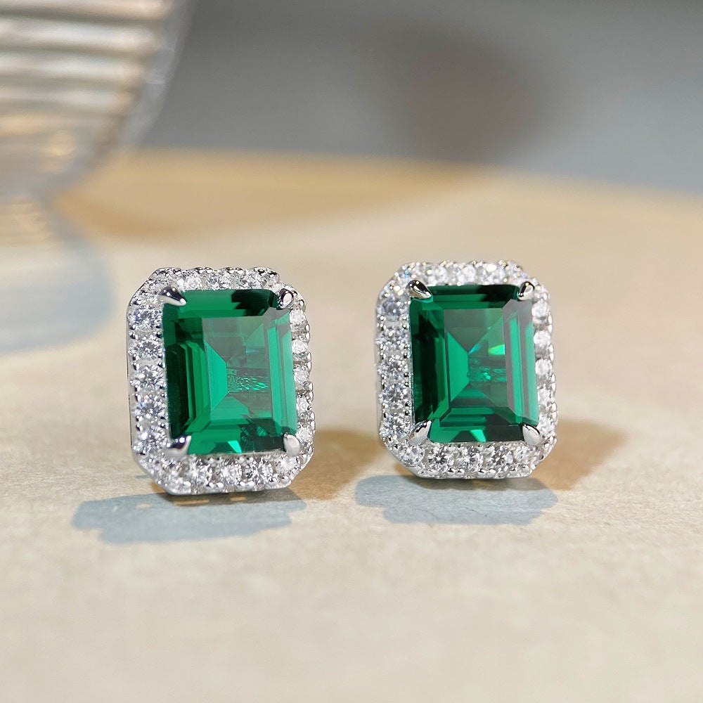 Emerald halo stud earrings in 925 sterling silver with diamond accents