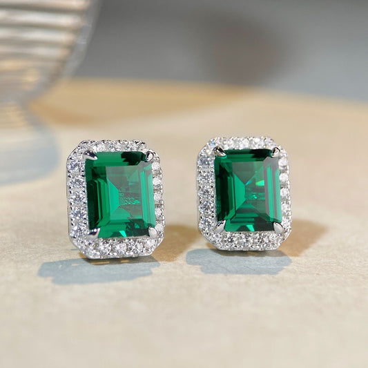 Emerald halo stud earrings in 925 sterling silver with diamond accents