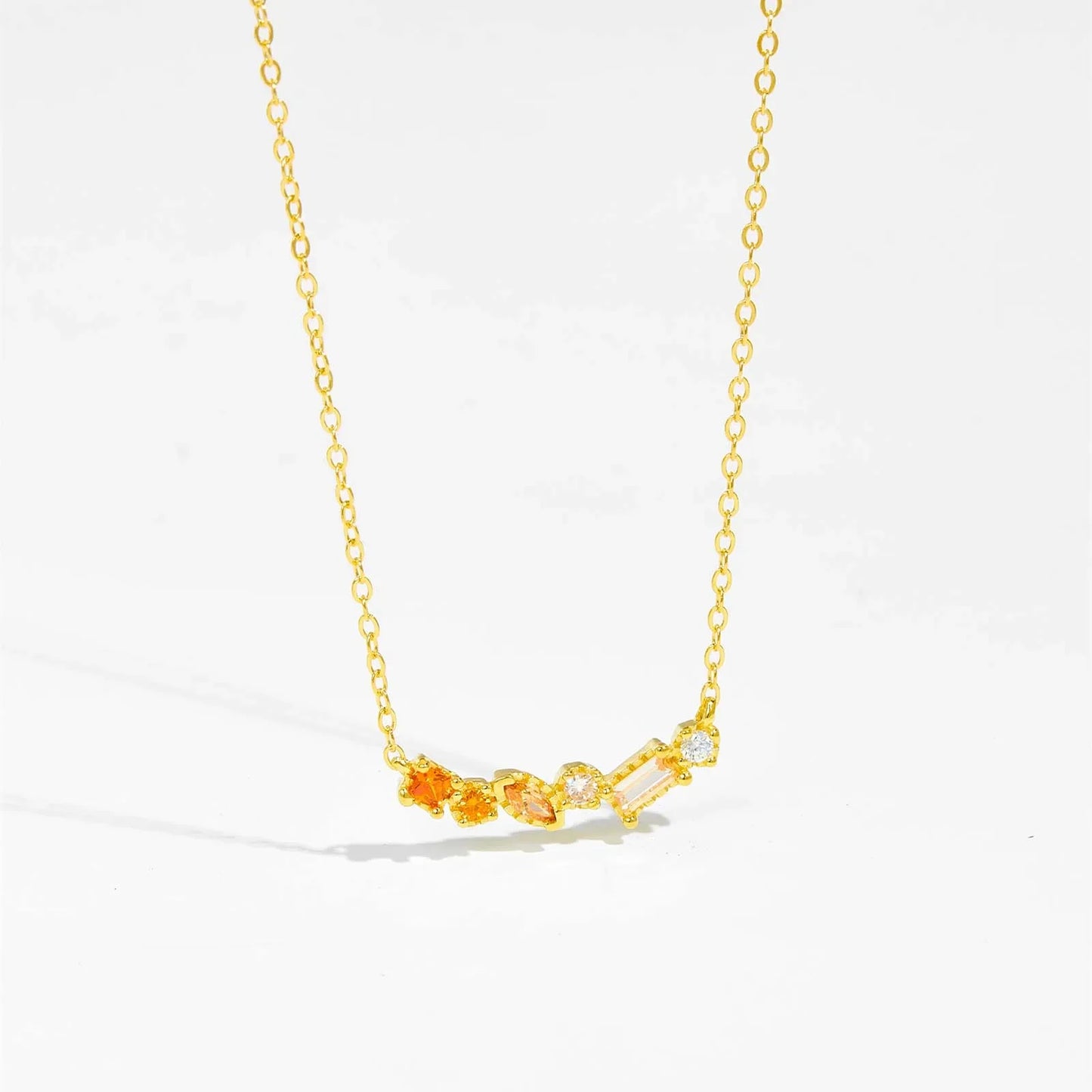 Gold-plated sterling silver necklace with blue CZ birthstone pendant by ANDYWEN