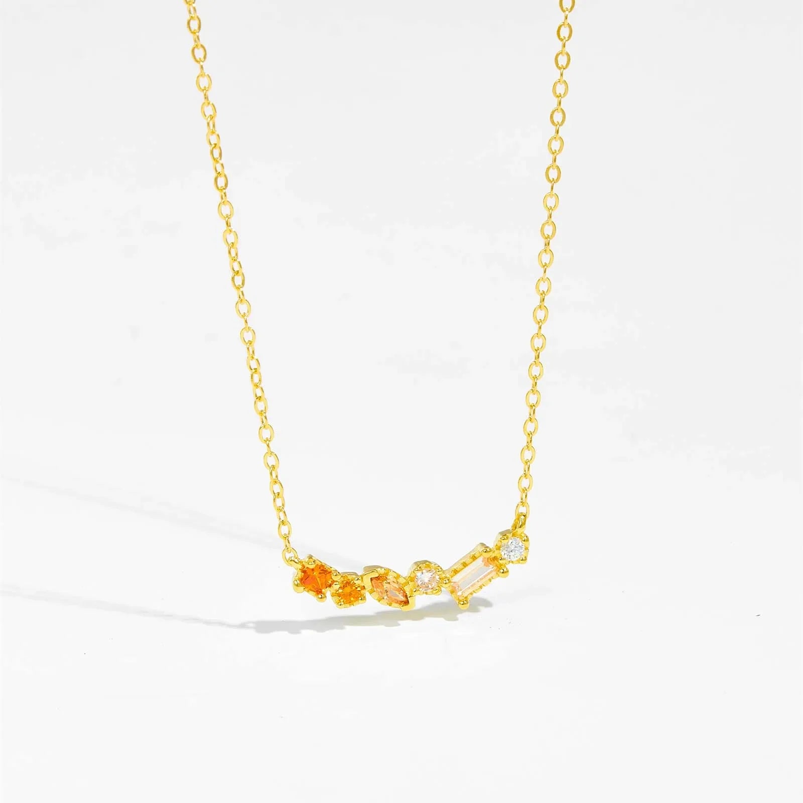 Gold-plated sterling silver necklace with blue CZ birthstone pendant by ANDYWEN