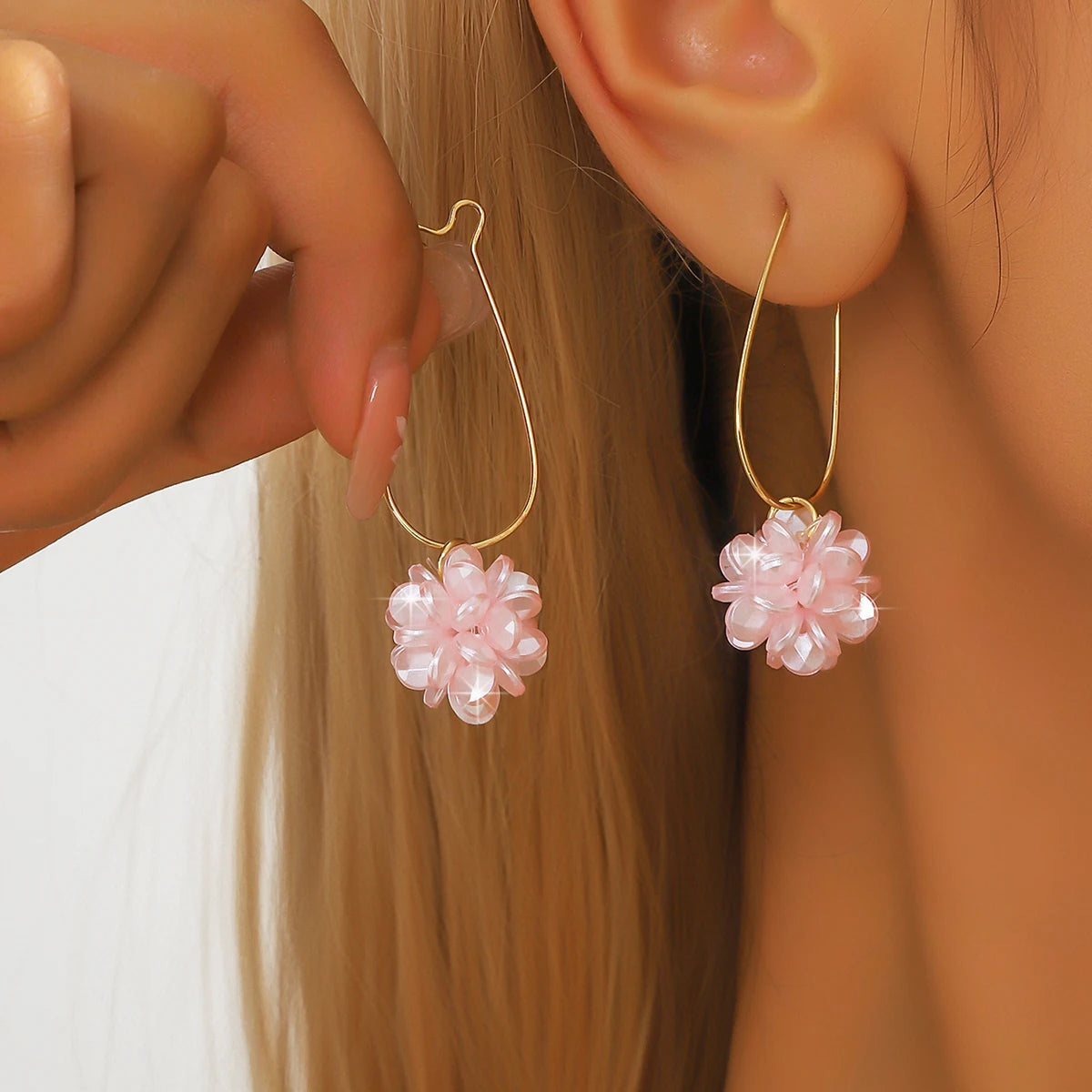 Woman wearing petal ball earrings at party – outdoor and holiday fashion accessory