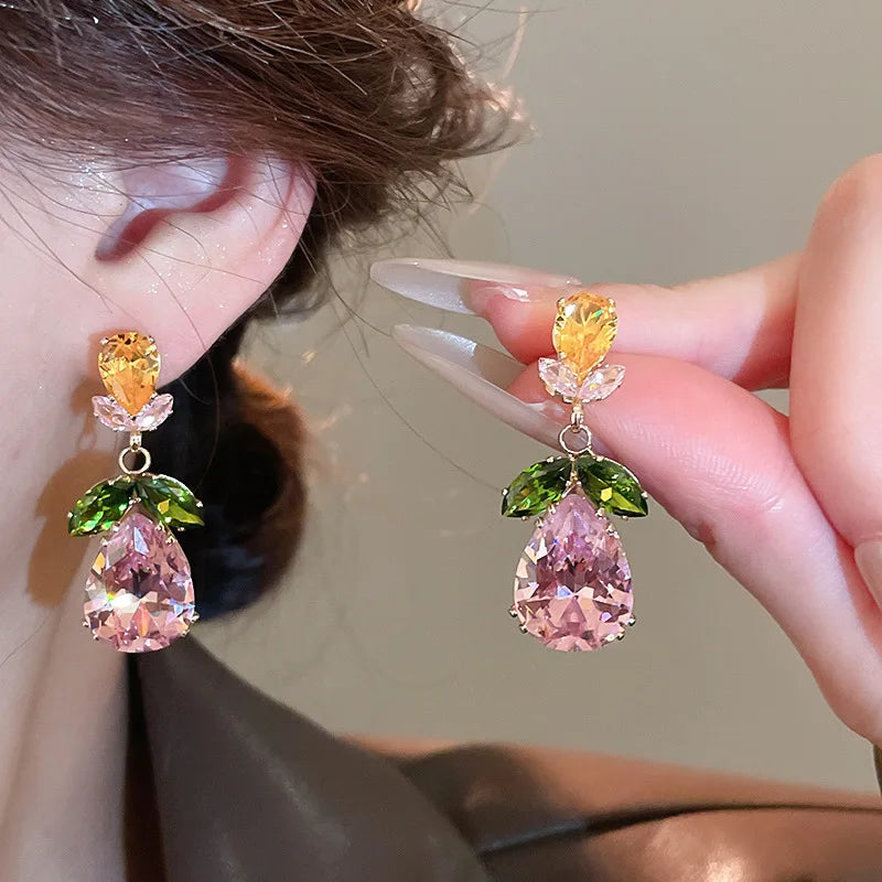 Woman wearing luxury zircon flower drop earrings – wedding and party jewelry
