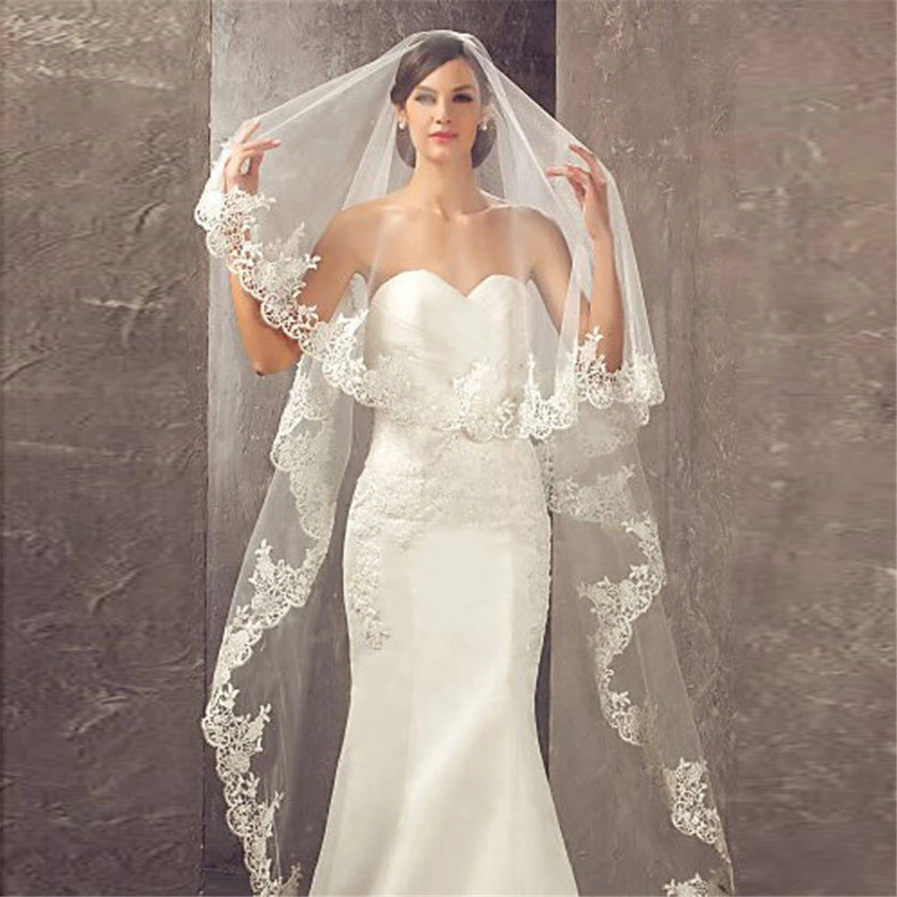 Bride wearing long lace edge veil – elegant cathedral-style wedding accessory