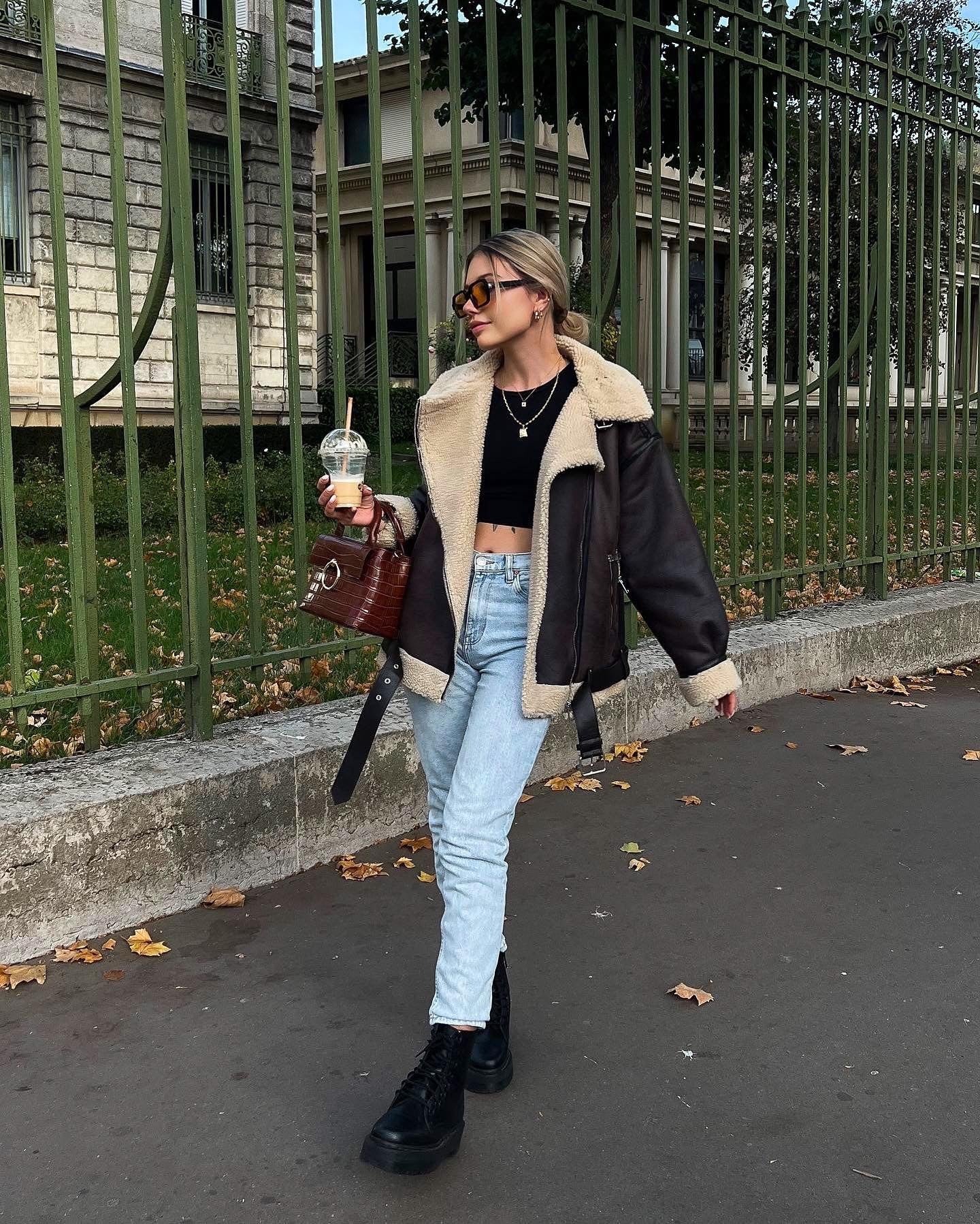 Model wearing fur-integrated dark brown jacket – trendy street-style winter look