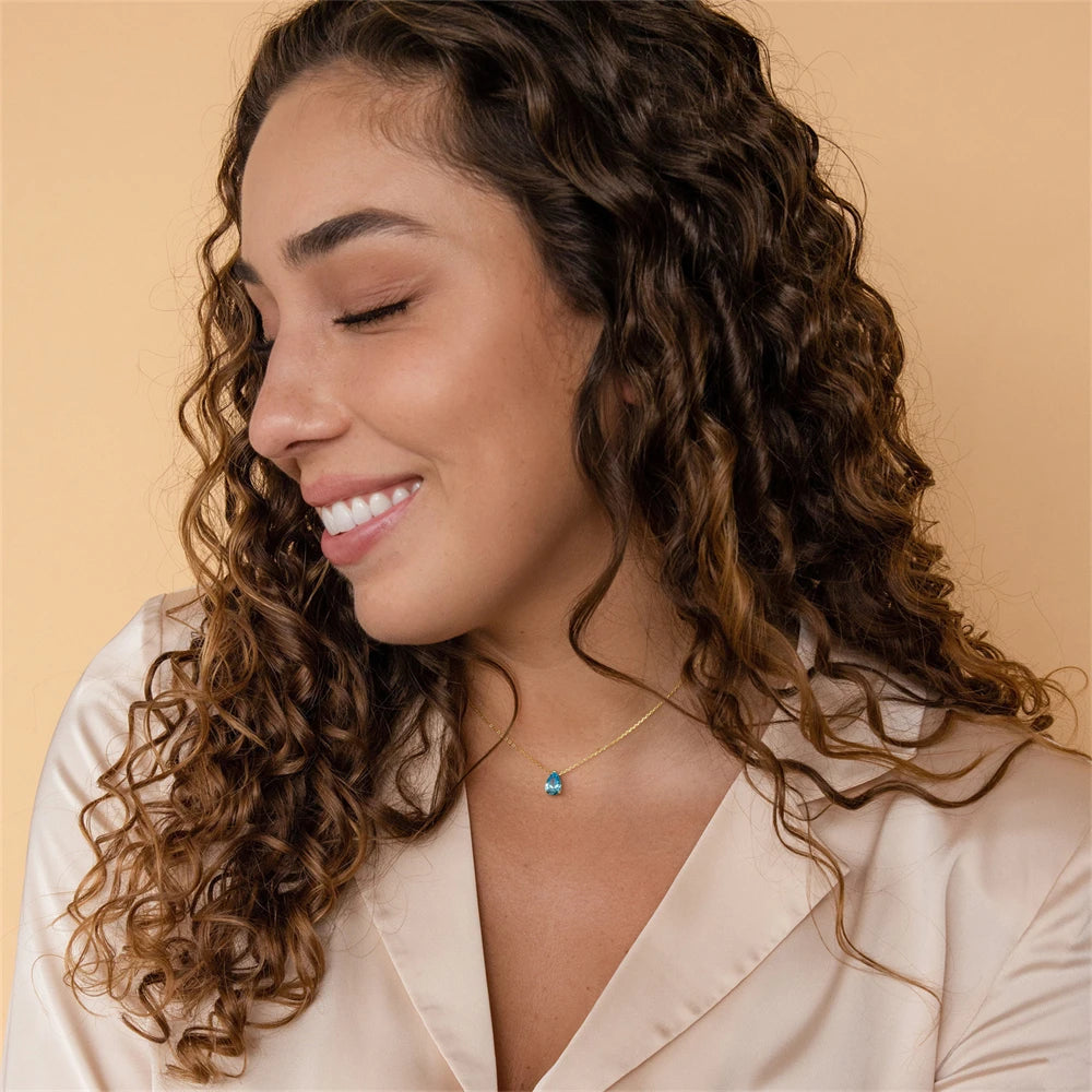 Woman wearing minimalist gold peridot birthstone necklace – boho style jewelry