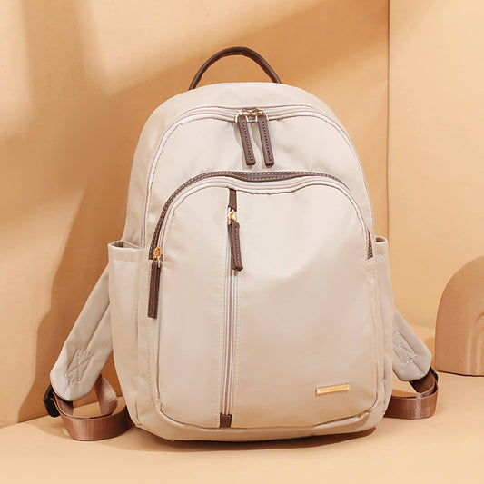 Lightweight women’s beige minimalist backpack with multiple zip compartments in two size options