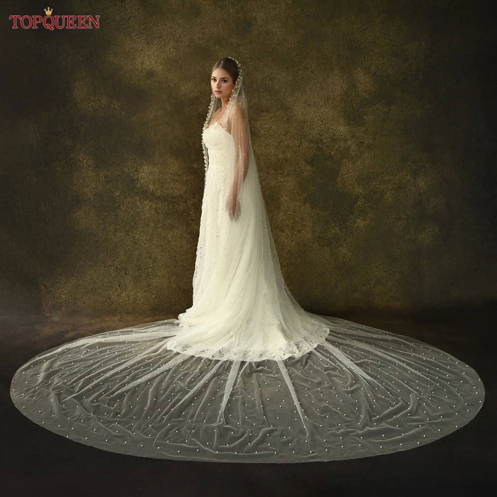 Bride wearing long cathedral pearl veil – flowing single-layer wedding accessory