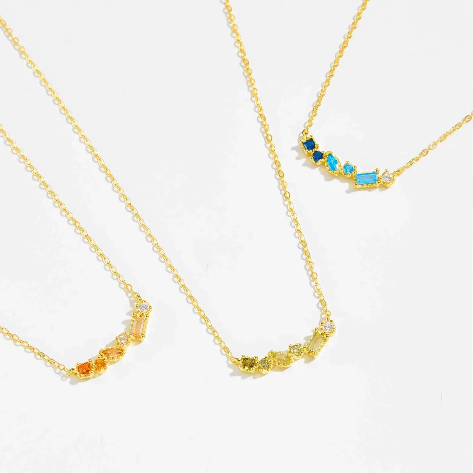 Gold-plated sterling silver necklace with blue CZ birthstone pendant by ANDYWEN